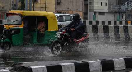 NEW DELHI INDIA JUNE 25 2023 Commuters out in the rain on NH24 in heavy rain on June 25 2023 in New Delhi India Heavy rainfall accompanied by lightning lashed several parts of the national capital Delhi and its adjoining areas in the early hours of Sundayのeditorial素材