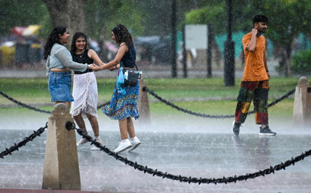 NEW DELHI INDIA JUNE 16 2023 People enjoying at Kartavya Path during Heavy rain on June 16 2023 in New Delhi India The India Meteorological Department had predicted light rain with gusty winds in Delhi NCR on Thursday According to the weather department tのeditorial素材