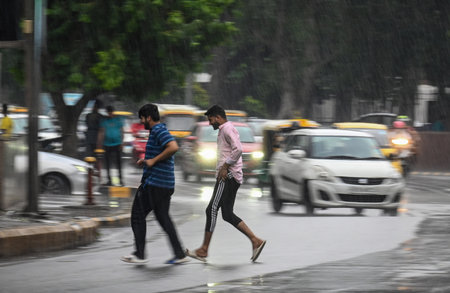 NEW DELHI INDIA JUNE 17 2023 Commuters out in the rain at connaught place area on June 17 2023 in New Delhi India The India Meteorological Department had predicted light rain with gusty winds in Delhi NCR on Thursday According to the weather department thのeditorial素材