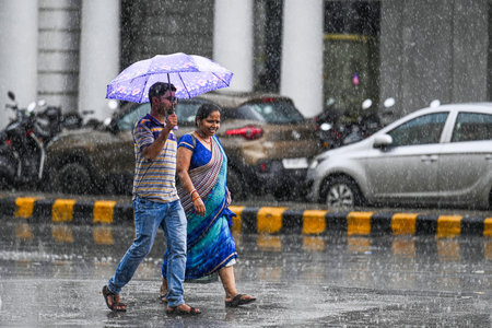 NEW DELHI INDIA JUNE 19 2023 Commuters during sudden rainfall at Connaught Place on June 19 2023 in...