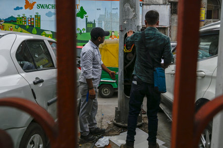 NEW DELHI INDIA JUNE 26 2023 Workers Repairing the an open electric circuit breaker box or a breaker box at New Delhi Railway station parking Area on June 26 2023 in New Delhi India A 35 year old woman who stepped onto a flooded street at the New Delhi Raのeditorial素材