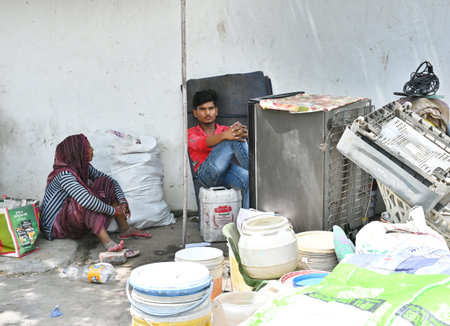 NEW DELHI INDIA JUNE 16 2023 Residents sit near their moveable households after a demolition drive...