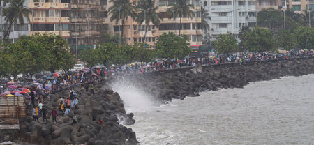 MUMBAI INDIA JUNE 25 2023 Crowd gathered to enjoy the rain at Marine Drive on June 25 2023 in Mumbai...