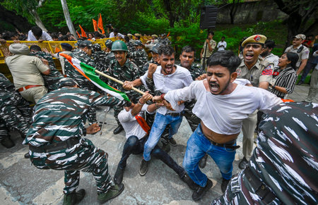 NEW DELHI INDIA JUNE 27 2023 Delhi Police and paramilitary personnel detain a member of Akhil...