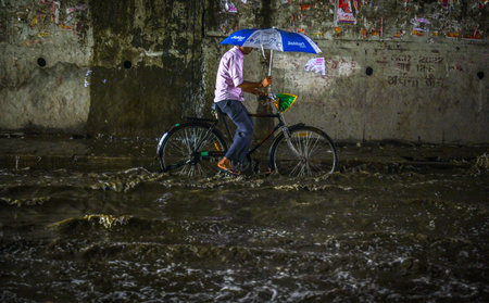 NEW DELHI INDIA JULY 8 2023 Commuters moves through a water logged street after heavy rains lashes out the city at Pandav Nagar Underpass on July 8 2023 in New Delhi India Delhi NCR was drenched with heavy rain on the intervening night of Friday and Saturのeditorial素材