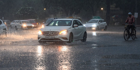 NEW DELHI INDIA JULY 15 2023 Commuters out during a heavy rain spell at Mandi House on July 15 2023...