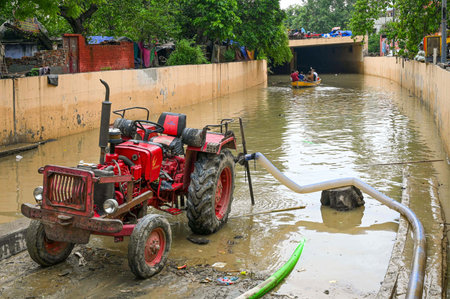 NEW DELHI INDIA JULY 16 2023 A tractor used to pull out the flood water from an underpass leading...