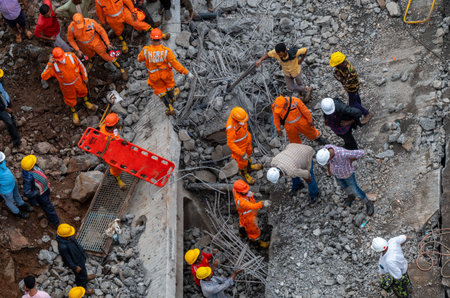 THANE, INDIA - AUGUST 1: Rescue workers in action after girder machine fell during construction of the third phase of Samruddhi Expressway on August 1, 2023 in Thane, India. 17 people died and three were injured in the incident. (Photo by Satish Bate/Hindのeditorial素材