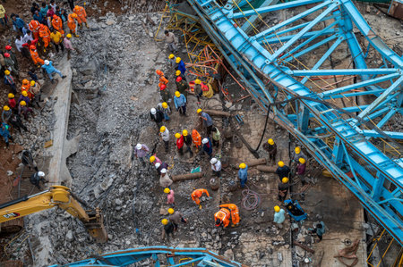 THANE, INDIA - AUGUST 1: Rescue workers in action after girder machine fell during construction of...