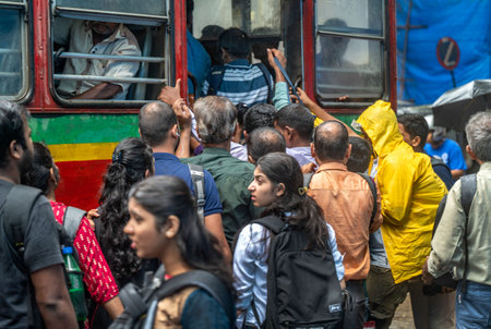 MUMBAI, INDIA - AUGUST 3: Crowd of commuters standing in a queue waiting for the bus during the morning peak hours at Mulund due to the ongoing strike on August 3, 2023 in Mumbai, India. 500 bus drivers who took part in the flash strike a day before contiのeditorial素材