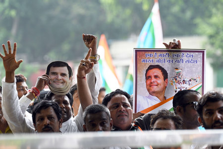 NEW DELHI, INDIA - AUGUST 4:  Congress workers raise slogans in support of party leader Rahul Gandhi to celebrate after the Supreme Court stayed the conviction of Gandhi in the 2019 criminal defamation case over his Modi surname remark, restoring his statのeditorial素材