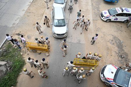 GURUGRAM, INDIA - AUGUST 8: Haryana police personnel deployed at Sohna-Nuh road near Rojka Meo wake of communal violence on August 8, 2023 in Gurugram, India. The attack on the procession last Monday had triggered communal clashes in Nuh, which quickly spのeditorial素材