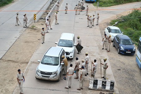 GURUGRAM, INDIA - AUGUST 8: Haryana police personnel deployed at Sohna-Nuh road near Rojka Meo wake of communal violence on August 8, 2023 in Gurugram, India. The attack on the procession last Monday had triggered communal clashes in Nuh, which quickly spのeditorial素材