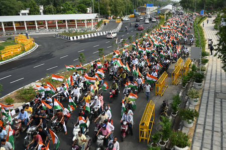 NEW DELHI, INDIA - AUGUST 11: People participate in  Har Ghar Tiranga Bike Rally of MPs from Pragati Maidan to Major Dhyan Chand Stadiums Gate No. 1 in the morning on August 11, 2023 in New Delhi, India. Har Ghar Tiranga campaign was launched from 13th âのeditorial素材
