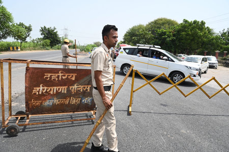 GURUGRAM, INDIA â€“ AUGUST 28: Police personnel barricading the road for vehicle checking at...
