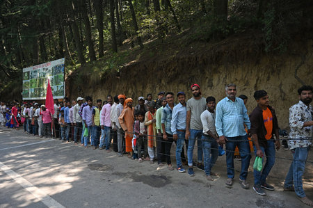 SRINAGAR, INDIA - AUGUST 30: A long queue of Hindu devotees wait to pay their obeisance at the...