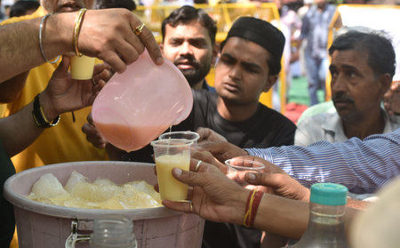NEW DELHI INDIA MAY 9 2023 A Man distribute sweet Milk s during the 17th day dharna their protest against the Wrestling Federation of India president Brij Bhushan Sharan at Jantar Mantar on May 9 2023 in New Delhi India Photo by Sonu Mehta Hindustan Timesのeditorial素材