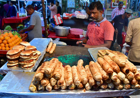MUMBAI INDIA APRIL 4 2023 Vendors cook and sell various delicious food delicacies on the roadside stalls in holy month of Ramadan near Minara Masjid at Pydhonie on April 4 2023 in Mumbai India Photo by Bhushan Koyande Hindustan Timesのeditorial素材