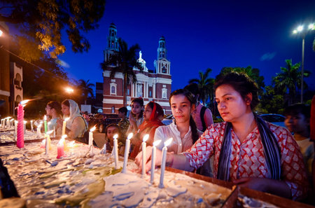 NEW DELHI INDIA APRIL 7 2023 Devotees light candles after evening prayer in Sacred Heart Cathedral...
