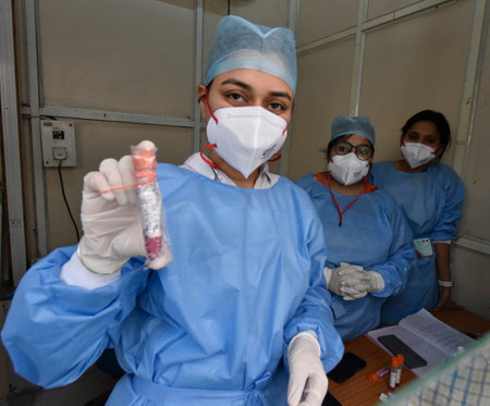 NEW DELHI INDIA APRIL 10 2023 Health care workers show the collected swab samples during the check COVID 19 preparedness amid rising cases of coronavirus at RML Hospital on April 10 2023 in New Delhi India India began a two day nationwide drill on Monday のeditorial素材