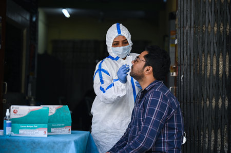 NEW DELHI INDIA APRIL 13 2023 A health worker collects a swab sample for coronavirus testing at Delhi Government dispensary Daryaganj on April 13 2023 in New Delhi India Photo by Raj K Raj Hindustan Timesのeditorial素材
