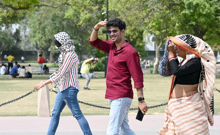 NEW DELHI INDIA APRIL 14 2023 Tourists out on a hot afternoon at Kartavya Path as the temperature...