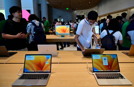 MUMBAI INDIA APRIL 18 2023 Visitors try various Apple device displayed during inauguration of Apple...