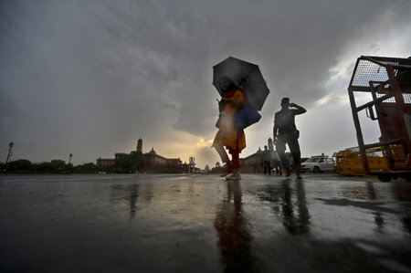NEW DELHI INDIA APRIL 20 2023 Tourist enjoying at Vijay Chowk during light rain on April 20 2023 in New Delhi India Photo by Raj K Raj Hindustan Timesのeditorial素材