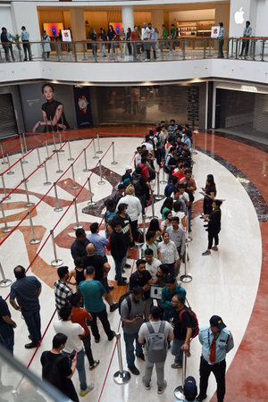 NEW DELHI INDIA APRIL 20 2023 Customers wait in line outside the new Apple Inc store ahead of its...