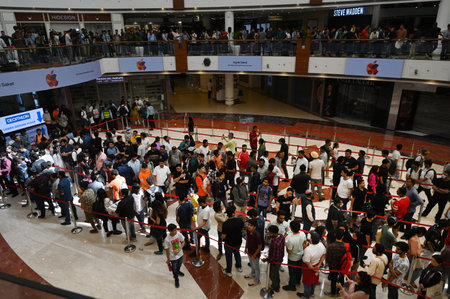 NEW DELHI INDIA APRIL 20 2023 Customers wait in line outside the new Apple Inc store ahead of its opening at Select City Walk at Saket on April 20 2023 in New Delhi India Apple CEO Tim Cook launched India s second Apple store today in Delhi couple of daysのeditorial素材