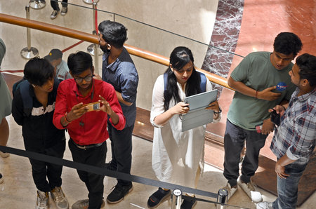 NEW DELHI INDIA APRIL 20 2023 Customers wait in line outside the new Apple Inc store ahead of its...