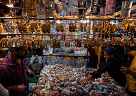 MUMBAI INDIA APRIL 20 2023 Muslim women select and wear colourful bangles from a stall as part of their upcoming Muslim Eid al Fitr festival shopping at Modh Ali Rd on April 20 2023 in Mumbai India Photo by Anshuman Poyrekar Hindustan Timesのeditorial素材