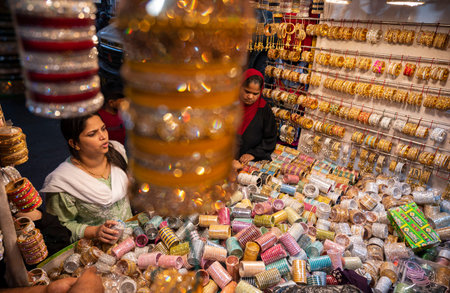 MUMBAI INDIA APRIL 20 2023 Muslim women select and wear colourful bangles from a stall as part of their upcoming Muslim Eid al Fitr festival shopping at Modh Ali Rd on April 20 2023 in Mumbai India Photo by Anshuman Poyrekar Hindustan Timesのeditorial素材