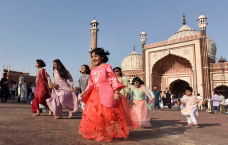 NEW DELHI INDIA APRIL 22 2023 Children enjoying after offering prayers on the occasion of Eid ul Fitr at Jama Masjid in Old Delhi on April 22 2023 in New Delhi India Muslims around the world are getting into the festive Eid spirit as the holy month of Ramのeditorial素材