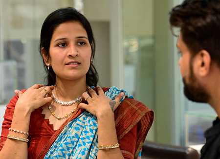 MUMBAI INDIA APRIL 22 2023 Shilpa Jain from Hyderbad shows necklace to her husband Rajesh Jain while buying Gold Jewellery on the occasion of Akshay Tritiya at Umedmal Trilokchand Zaveri Jewelry at Kalbhadevi on April 22 2023 in Mumbai India Akshaya Tritiのeditorial素材
