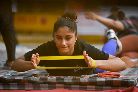 NEW DELHI INDIA APRIL 28 2023 Indian Wrestler Vinesh Phogat along with Sangeeta Phogat warming up during a practice session while on their ongoing protest against Wrestling Federation of India s President in early hours of the morning at Jantar Mantar on のeditorial素材