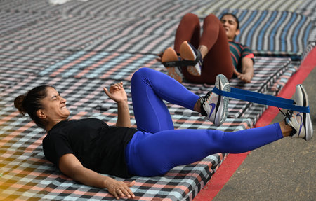 NEW DELHI INDIA APRIL 28 2023 Indian Wrestler Vinesh Phogat along with Sangeeta Phogat warming up during a practice session while on their ongoing protest against Wrestling Federation of India s President in early hours of the morning at Jantar Mantar on のeditorial素材