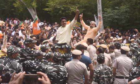 NEW DELHI INDIA APRIL 27 2023 Delhi BJP workers attempt to cross a police barricade during a protest...