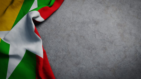 Flag of Myanmar on concrete backdrop. Myanmar flag background with copy spaceの写真素材