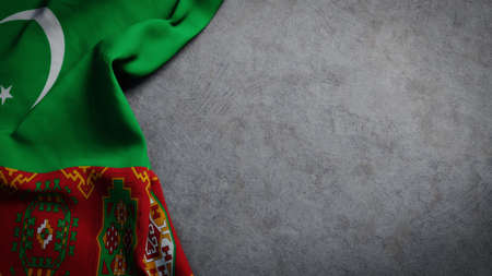 Flag of Turkmenistan on concrete backdrop. Turkmenistan flag background with copy spaceの写真素材