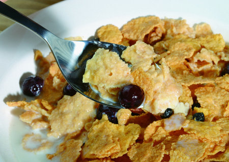 Grapes and dry cake on spoon