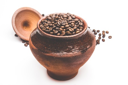 Grains of coffee in a decorative pot, isolatedの写真素材