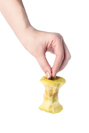 the stub of a green apple in woman handの写真素材