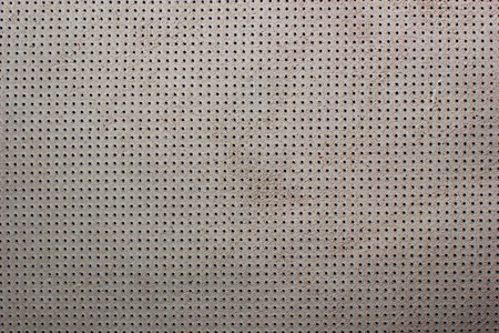 White beige velvet perforated leather texture backgroundの写真素材
