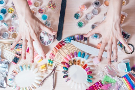 Nail art concept. Woman making decoration on the nails on white tableの写真素材