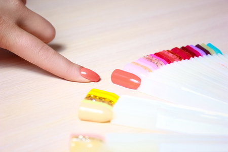 Girls fingers with multicolored nails. Female hands with fashion summer manicure and nails samples. Stylish summer manicure.の写真素材