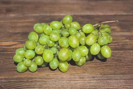 Grapes bunch on a old wooden background. Top viewの写真素材
