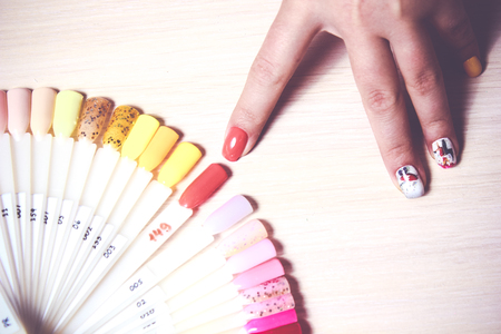 woman choose the color of Polish for manicure. design for nails. testers nail Polish.Fashion manicure.の写真素材