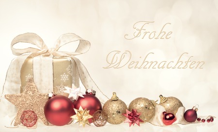 Christmas gift box and balls with grettins text Frohe Weihnachtenの写真素材