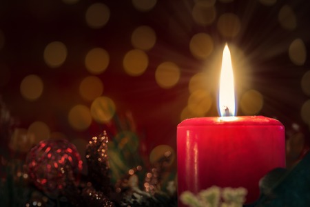 Christmas decoration with burning red candle. の写真素材